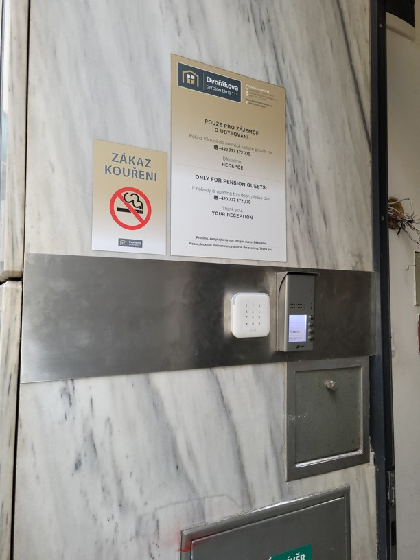 Nové venkovní tablo domovního telefonu a čtečka přístupového systému u hlavního vstupu do penzionu v Brně.